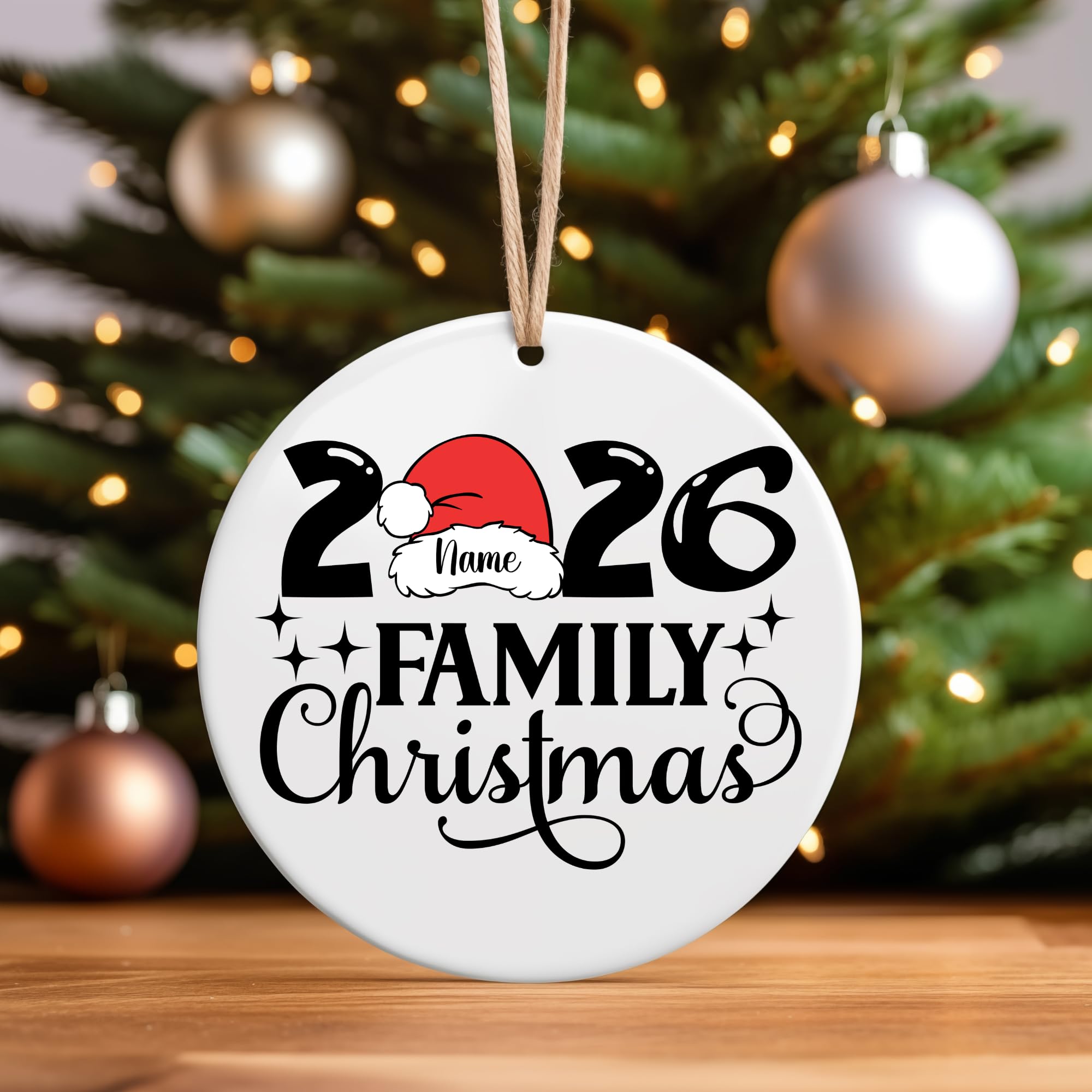 A white ceramic ornament reading 2026 Family Christmas hanging on a decorated tree
