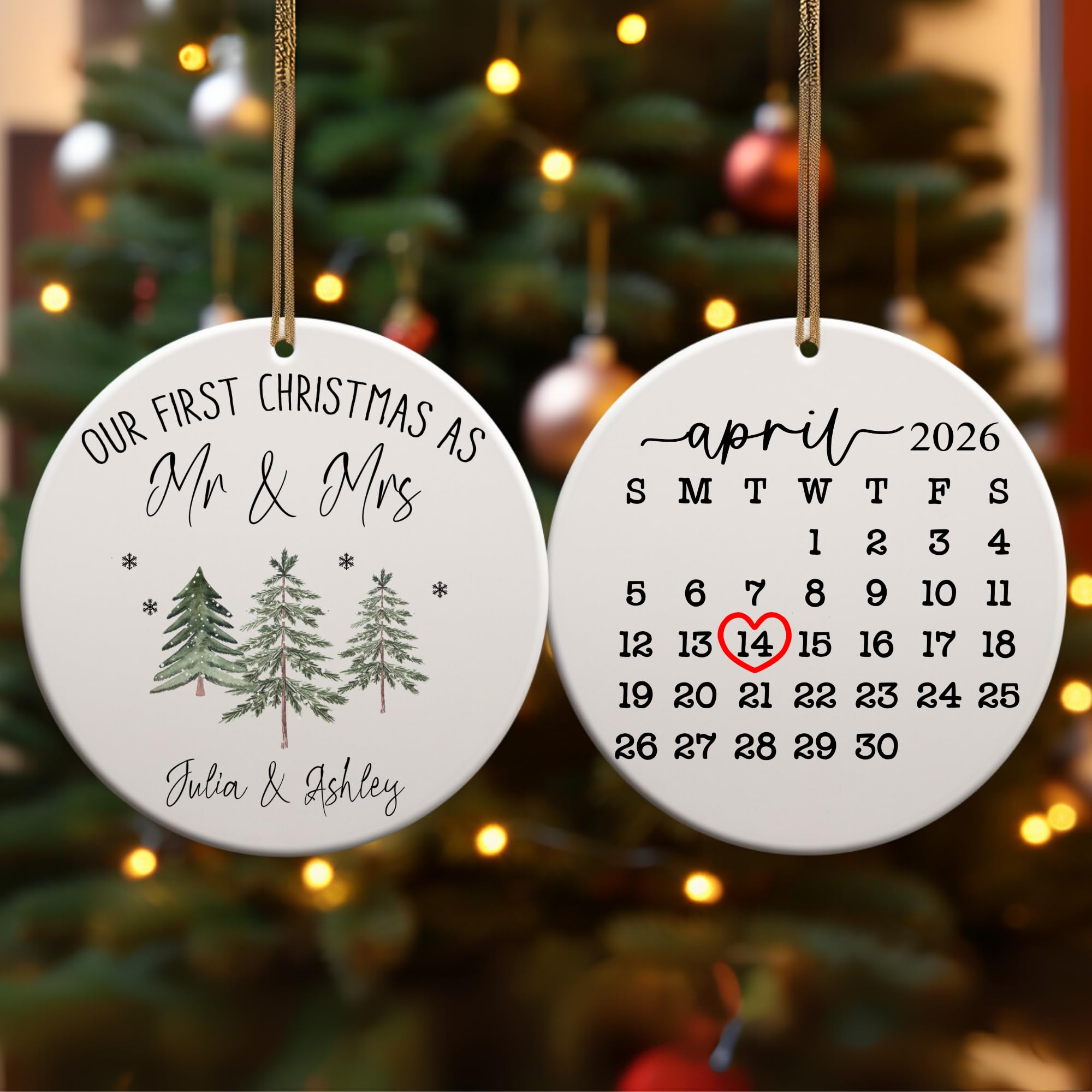 Two ceramic Christmas ornaments, one with a calendar highlighting a date, hanging on a tree