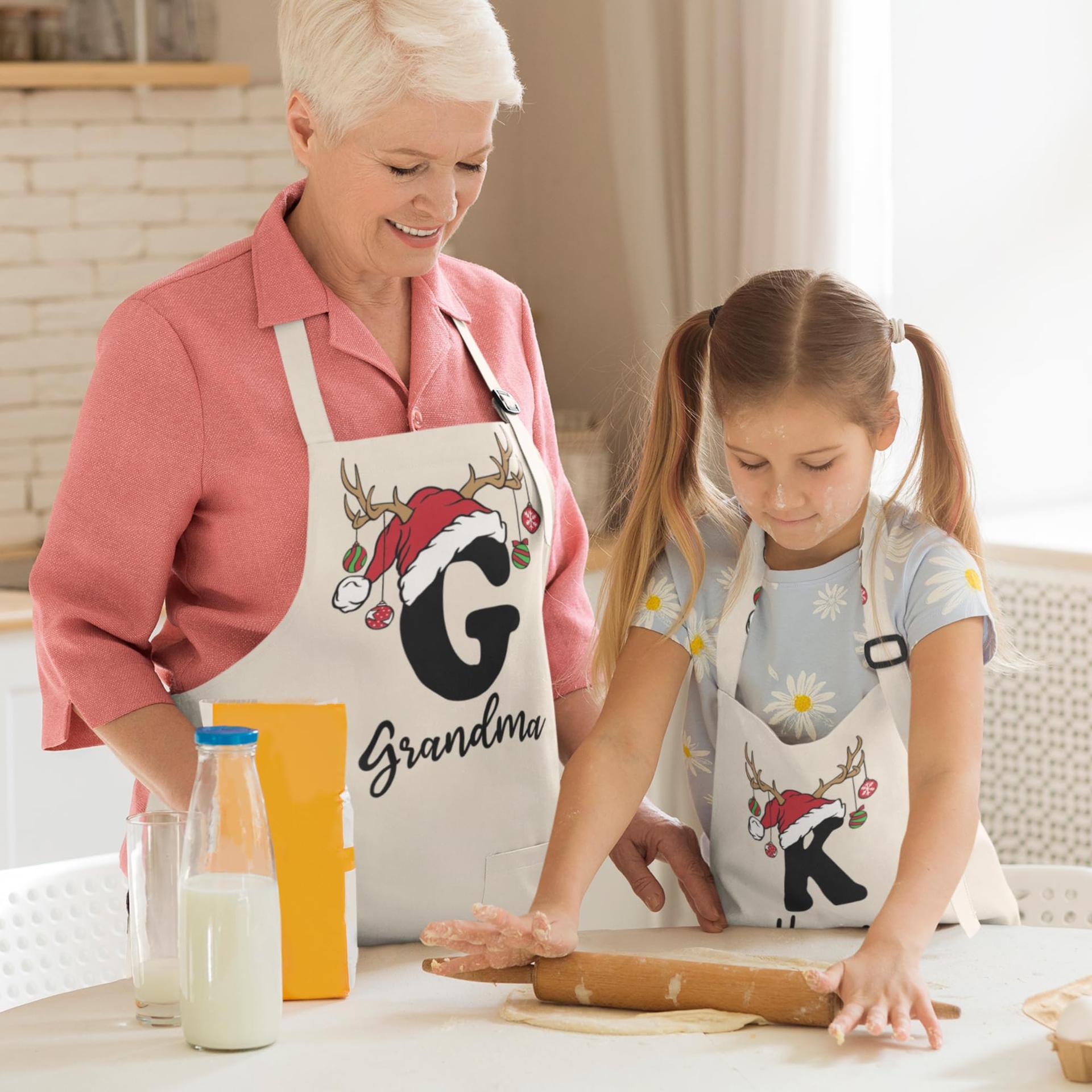 A grandmother and granddaughter baking together in matching personalized Christmas aprons