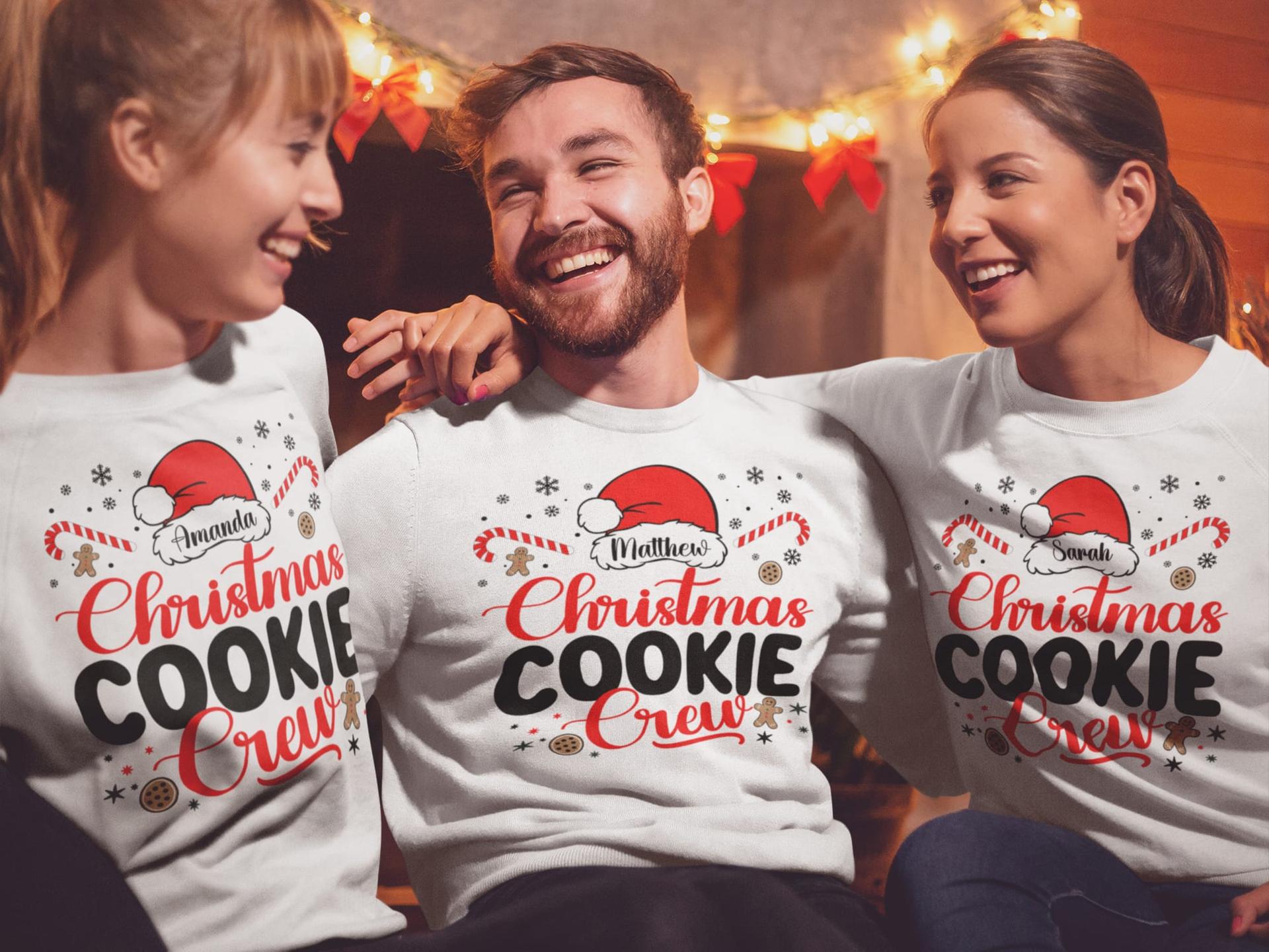 Friends laughing in matching Christmas Cookie Crew shirts