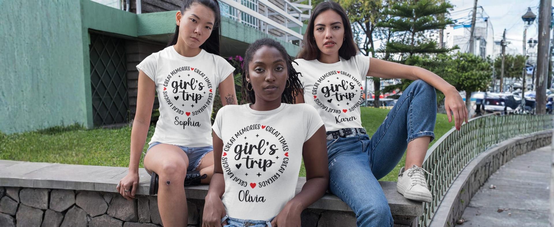 Friends sitting outdoors in matching personalized girls trip shirts