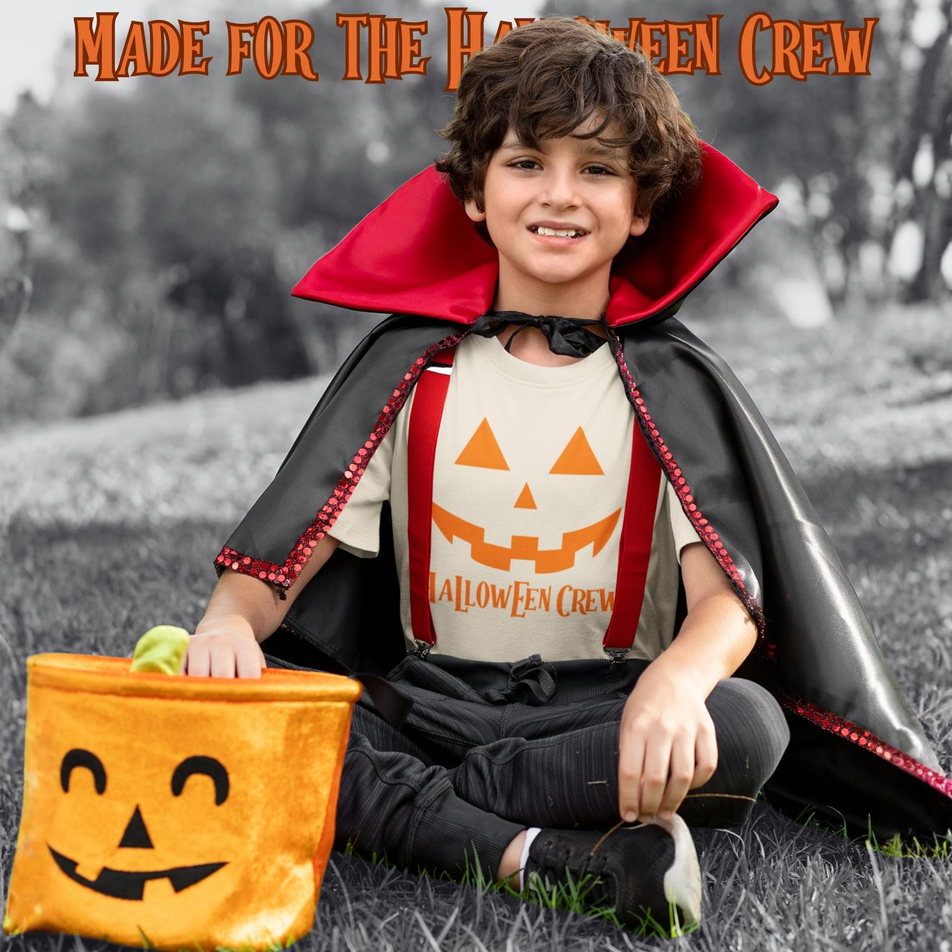 A boy in a vampire costume wearing a Halloween crew shirt