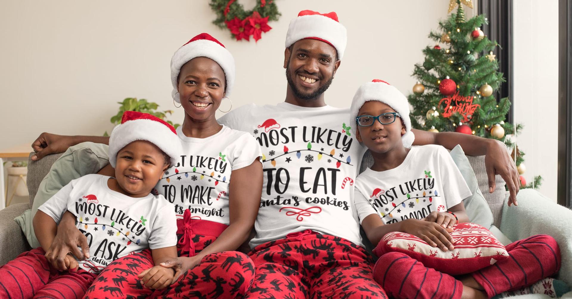 A family in Santa hats wearing matching “Most likely to” Christmas shirts