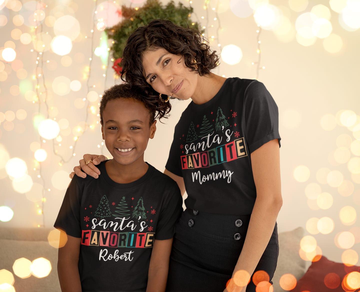A mother and son in matching Santa’s Favorite shirts